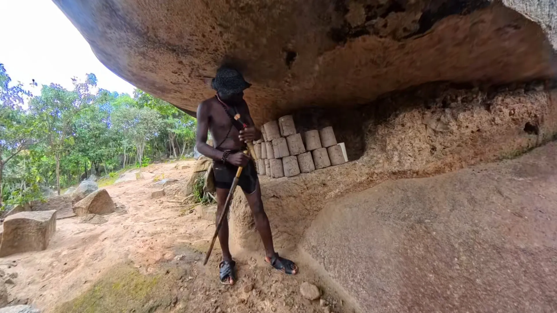 Traditional mud bricks drying beneath a rock overhang