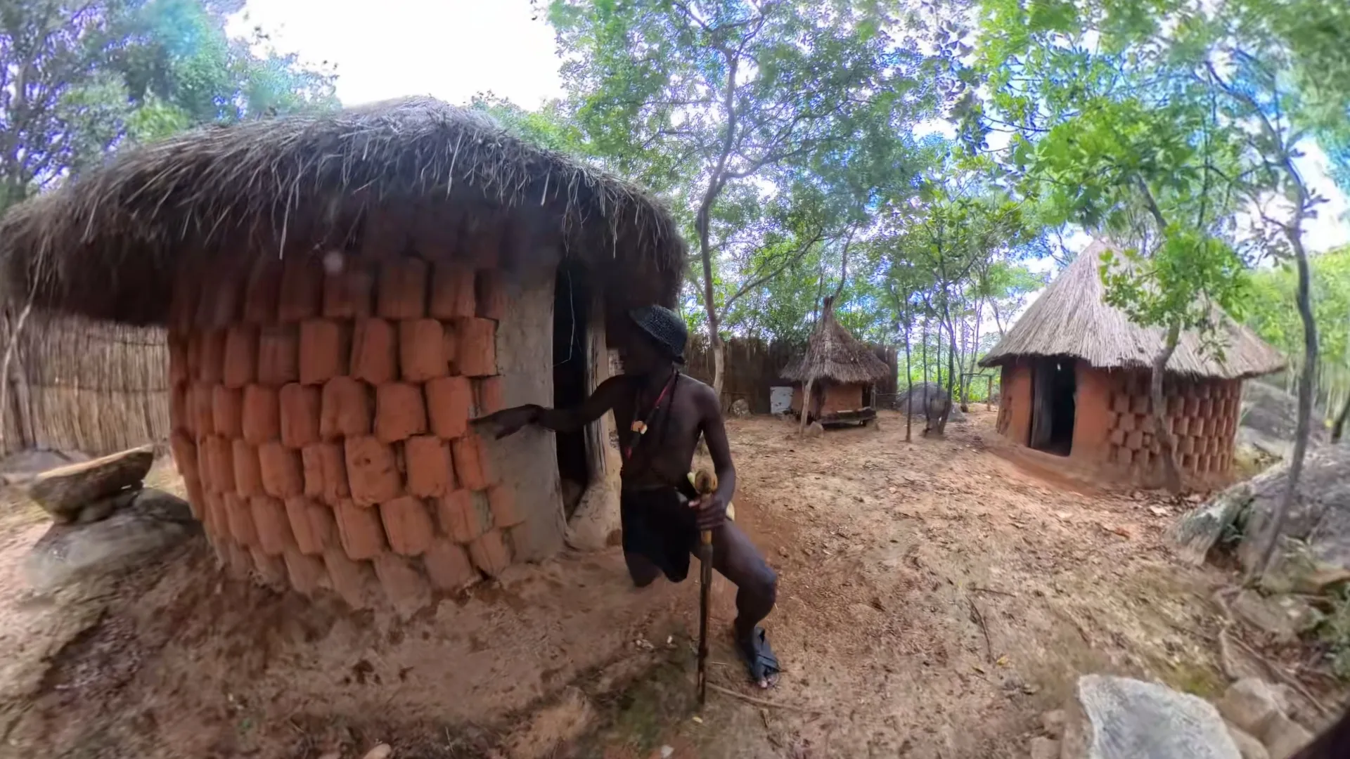 Trymore Ngolanga outside the traditional Shona homestead at paMusha